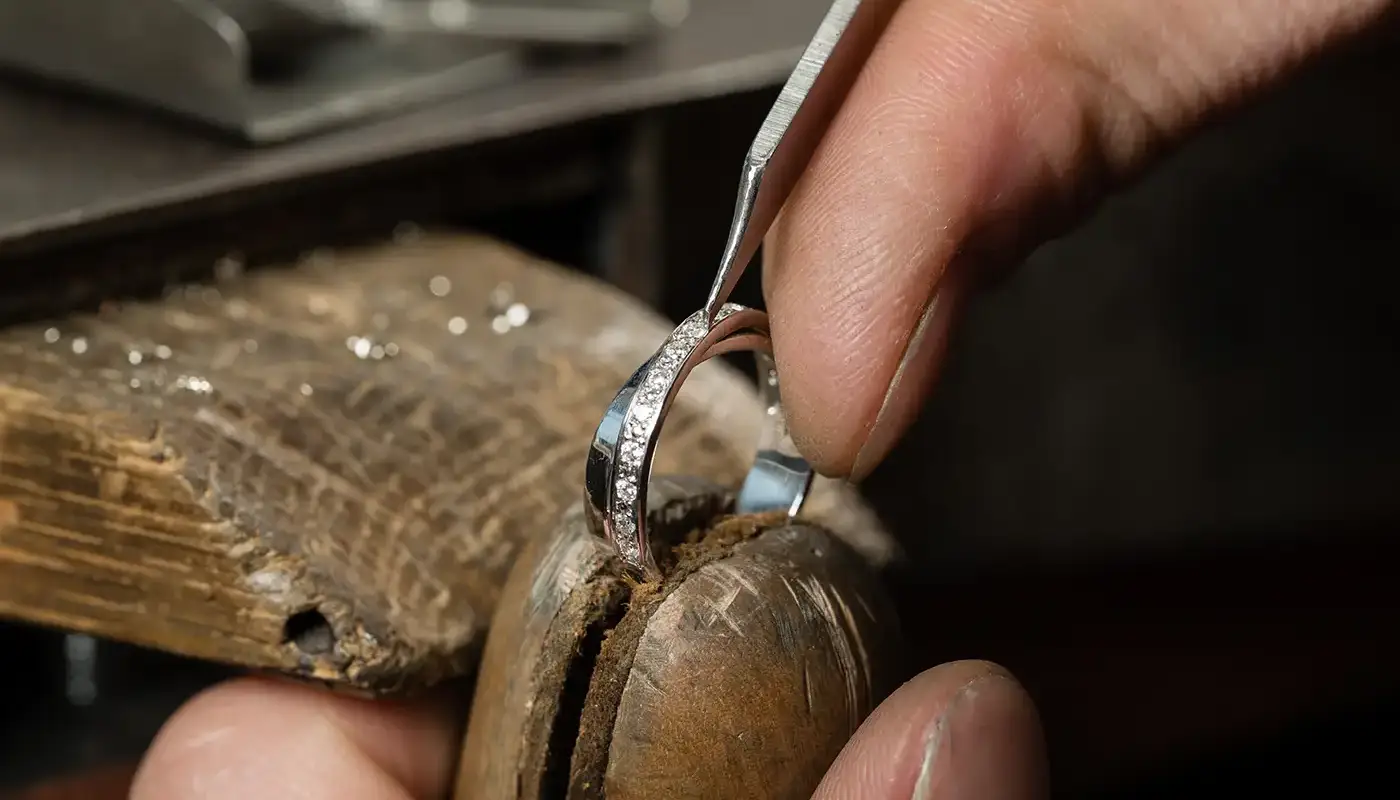 Jeweler working on diamond ring using a holding device at Manning Jewelry