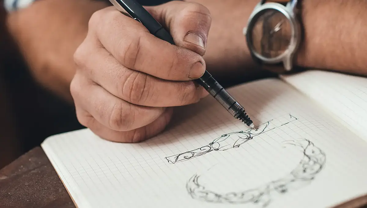 Jewelry designer sketching a diamond ring during appraisal process at Manning Jewelry